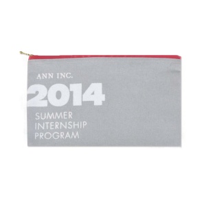 A gray pouch adorned with "ANN INC. 2014 Summer Internship Program" in white, featuring a vibrant red zipper. It's an inspiring example for those seeking custom pouch ideas that blend style and functionality.