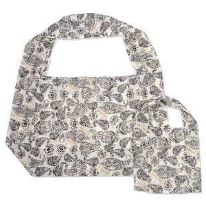 A reusable fabric shopping bag crafted from durable muslin showcases a black and white paisley pattern on a light background. The matching pouch, folded neatly beside the open bag, highlights the intricate design.