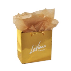 Gold gift bag with LaViano Jewelers printed in white, featuring shiny gold handles and filled with light brown tissue paper—perfect for the holiday season.