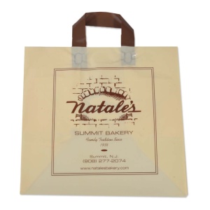 A beige, grab-and-go bag with brown handles displays the Natales Summit Bakery logo and a brick oven graphic. It proudly bears the text "Family Tradition Since 1938" along with contact details for Summit, NJ.