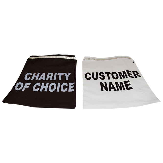 Two large fabric bags are shown. The bag on the left is black with white text reading CHARITY OF CHOICE, and the bag on the right is white with black text reading CUSTOMER NAME. Both bags are empty and laid flat.