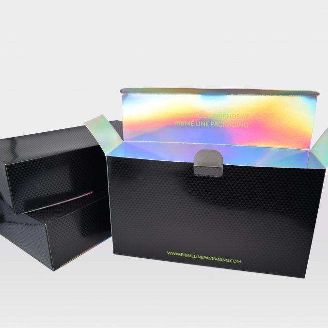 A black textured box with an iridescent interior is open, revealing its label, Prime Line Packaging. Another similar closed box is in the background on a plain white surface.
