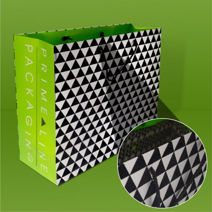 A shopping bag featuring a black and white triangle pattern on the sides, with Prime Line Packaging printed in green on the edges. Theres a close-up inset highlighting the bags handle and pattern. The background is a matching green.