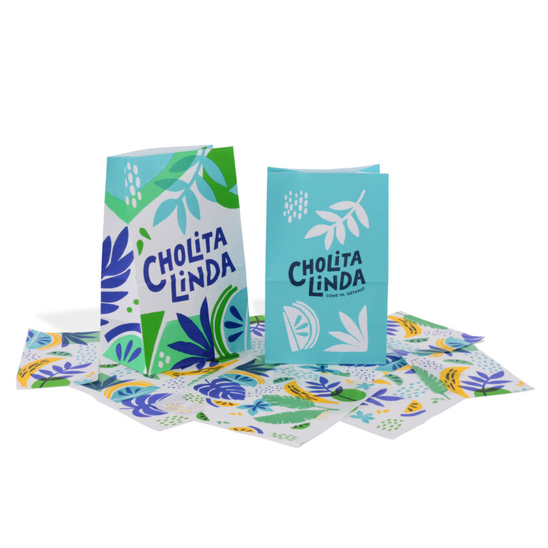 Two colorful greeting cards with Cholita Linda text, surrounded by matching decorative envelopes. The design features vibrant leaves and abstract shapes in shades of blue, green, and yellow on a white background.